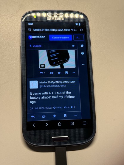 A Samsung phone displaying a Mastodon social media post.